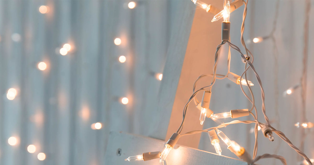 Clear Christmas lights on white wall