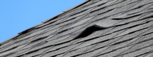 creased shingles and roof damage